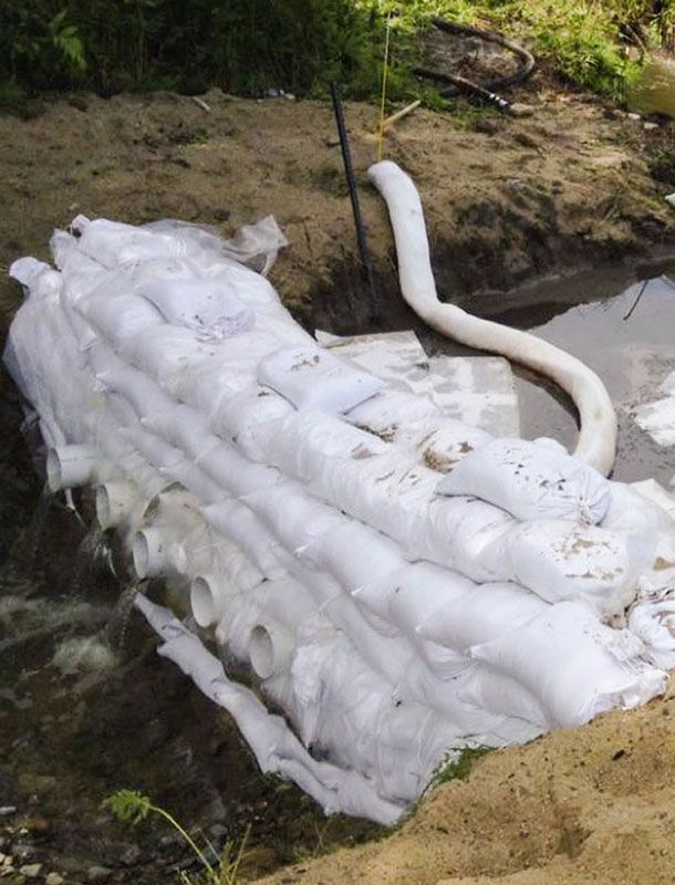 Sandbags vs oil spill dam