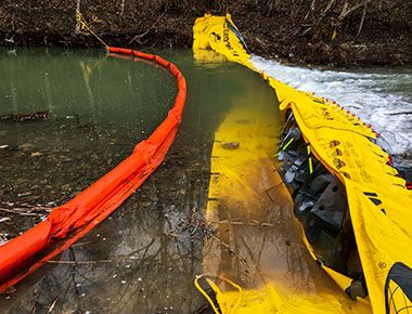 Use containment boom with underflow dam